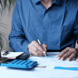 Man analyzing financial documents for home sale in Fredericksburg.