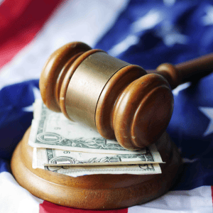Gavel resting on dollar bills representing capital gains tax.