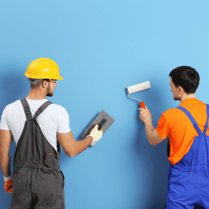 Two workers painting a wall in a home renovation project in Fredericksburg VA.