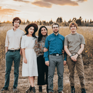 Group of five diverse people standing in a field during sunset in Fredericksburg, Virginia.