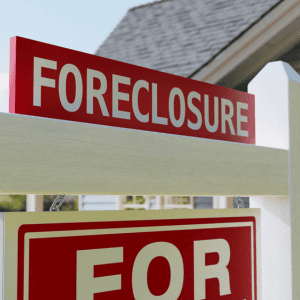 Foreclosure sign indicating house is for sale due to missed mortgage payments.