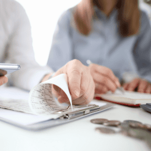 Person reviewing documents during a house selling consultation.