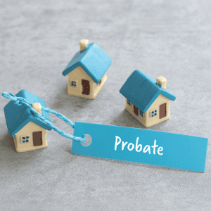 Miniature houses with probate tag for inherited property sale.