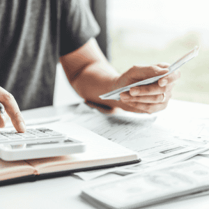 Person analyzing financial documents for house buying process.